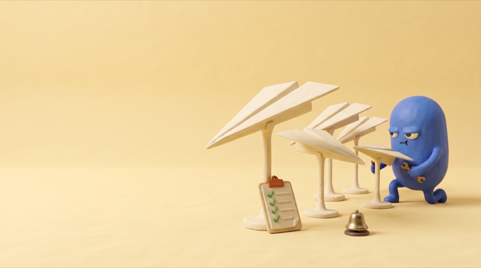 Five clay paper planes parked on stands in a row, a blue clay figure tightening the smallest one with a spanner